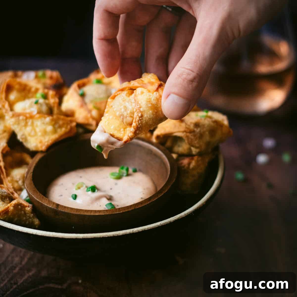 dipping a pulled pork wonton