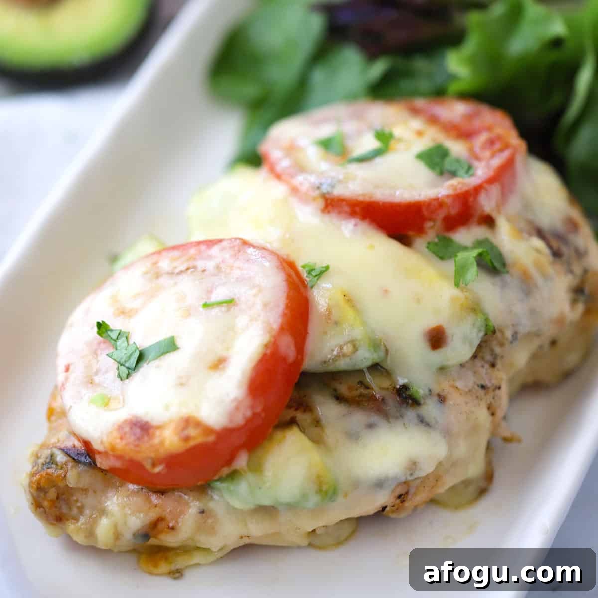 california chicken recipe on a white platter served with a green salad, california chicken grill, chicken california.