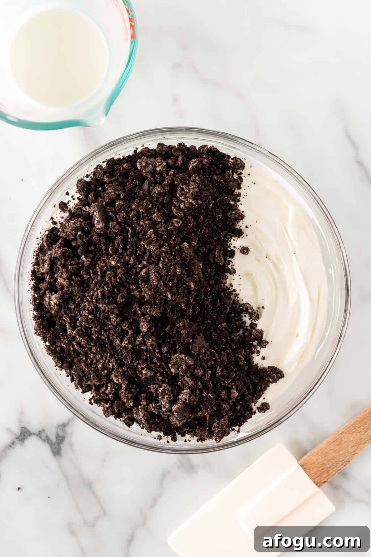 adding the oreos to the cream cheese and whipped cream