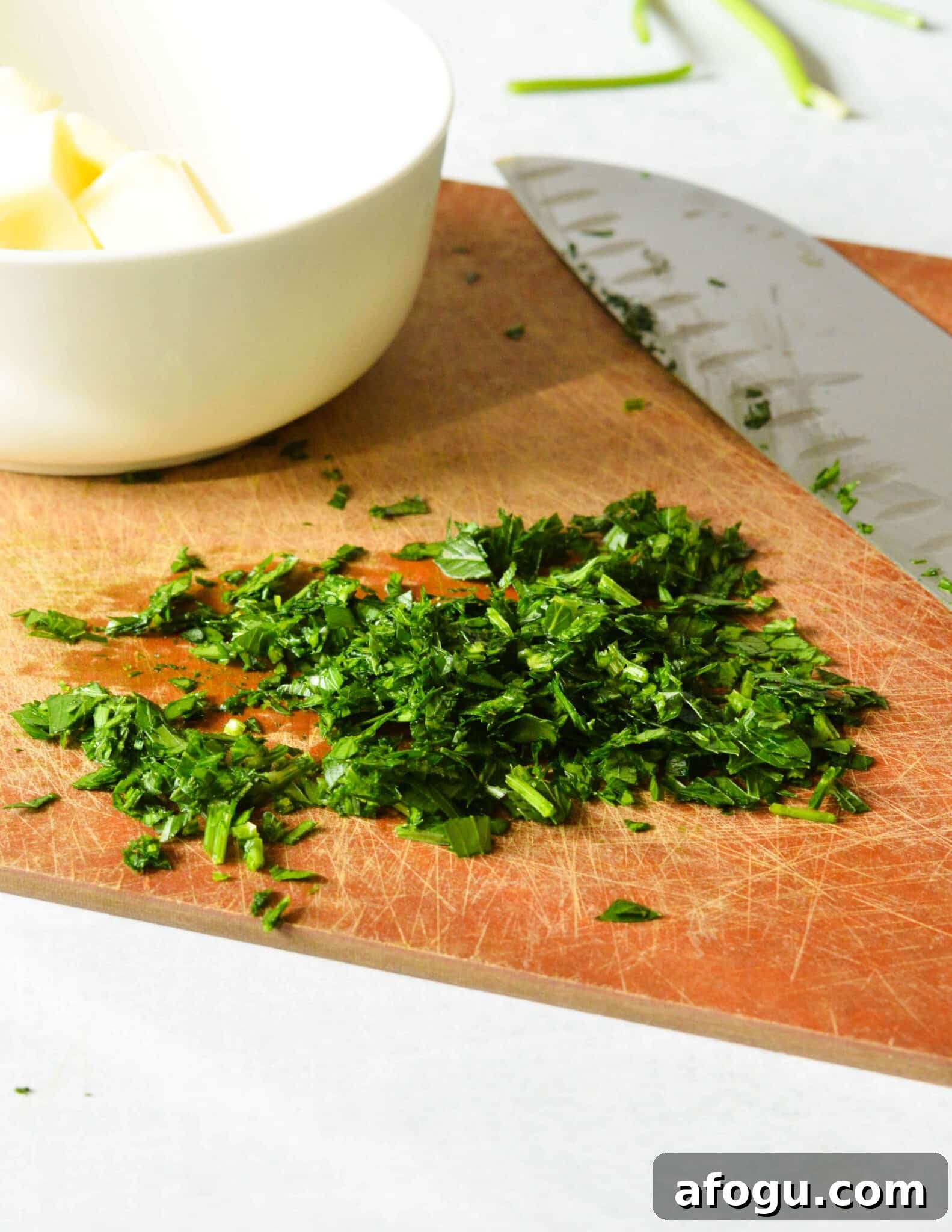 minced herbs on a cutting board. 