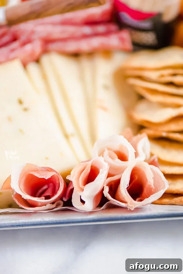 closeup of prosciutto roses on a charcuterie board