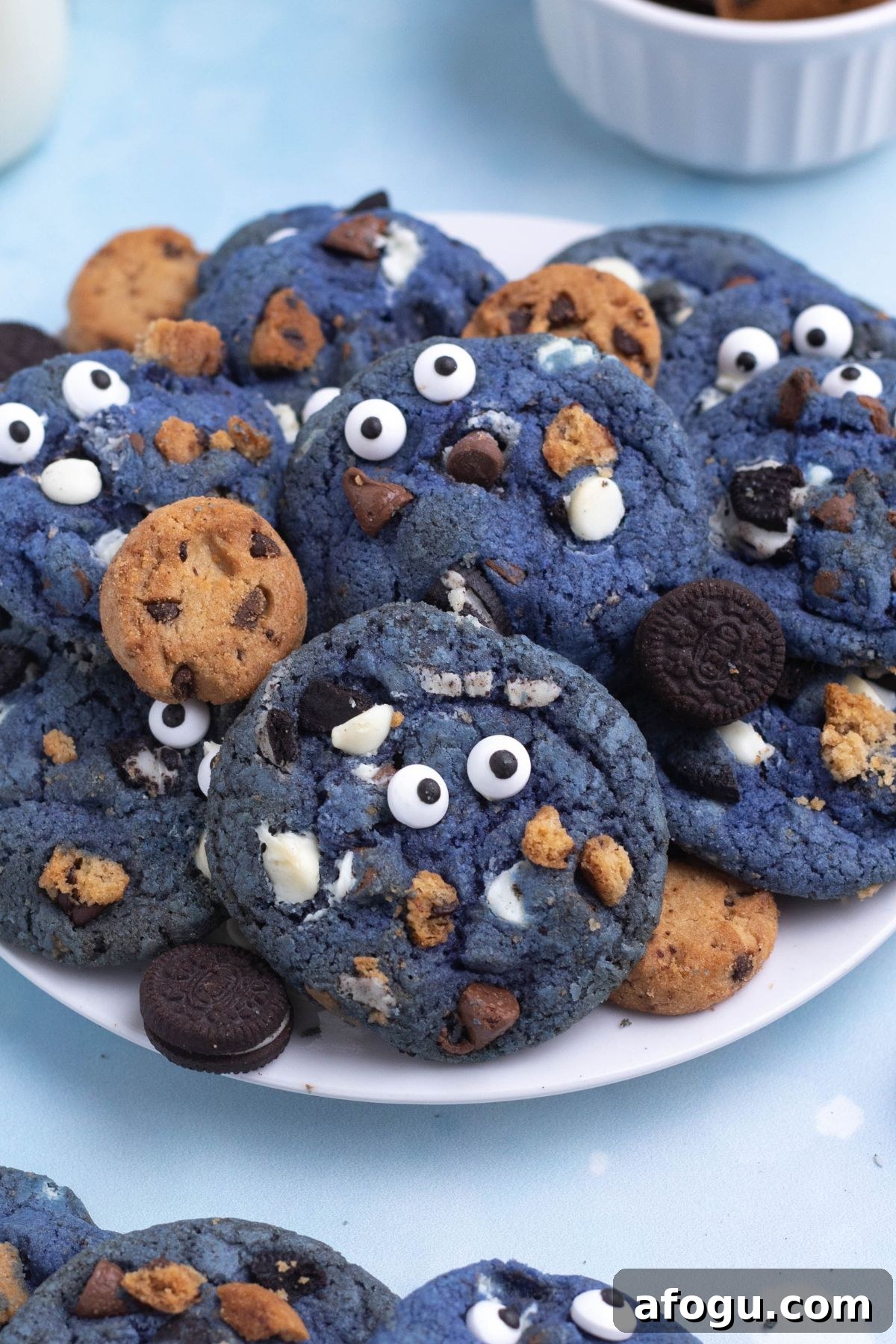 Bright blue cookie monster cookies filled with crushed cookies, chocolate and white chocolate chips.