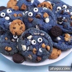 Bright blue cookie monster cookies filled with crushed cookies, chocolate and white chocolate chips.