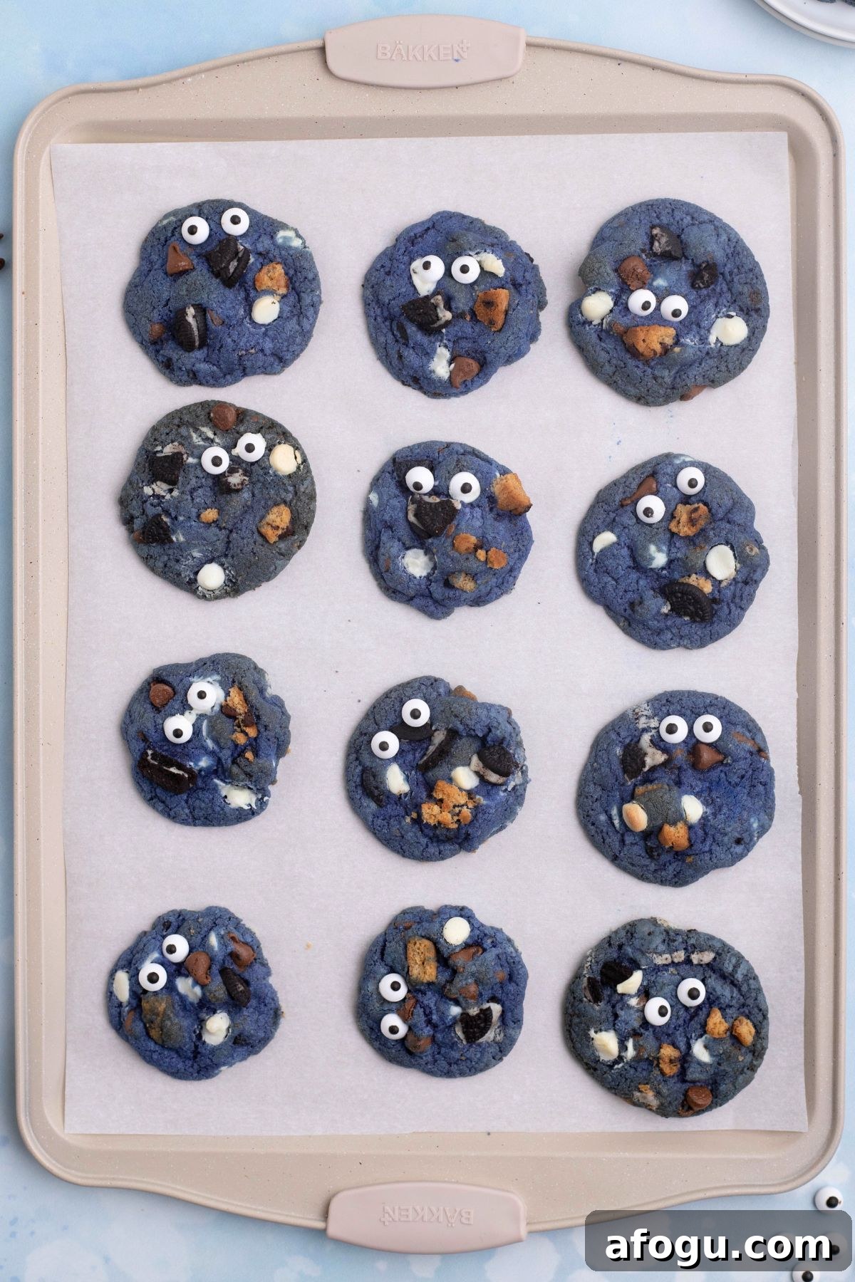 Baked cookies on a cookie sheet, lined with parchment paper. 
