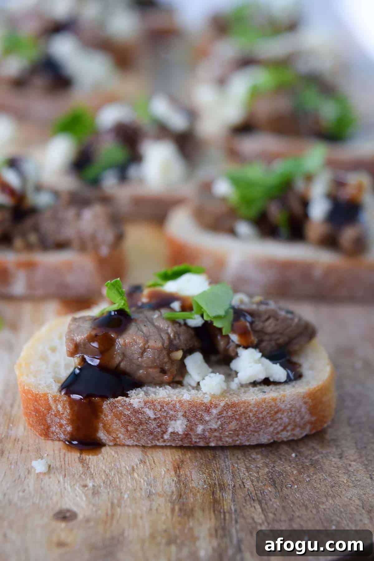 Blue Cheese and Steak Crostini topped with parsley close up side view