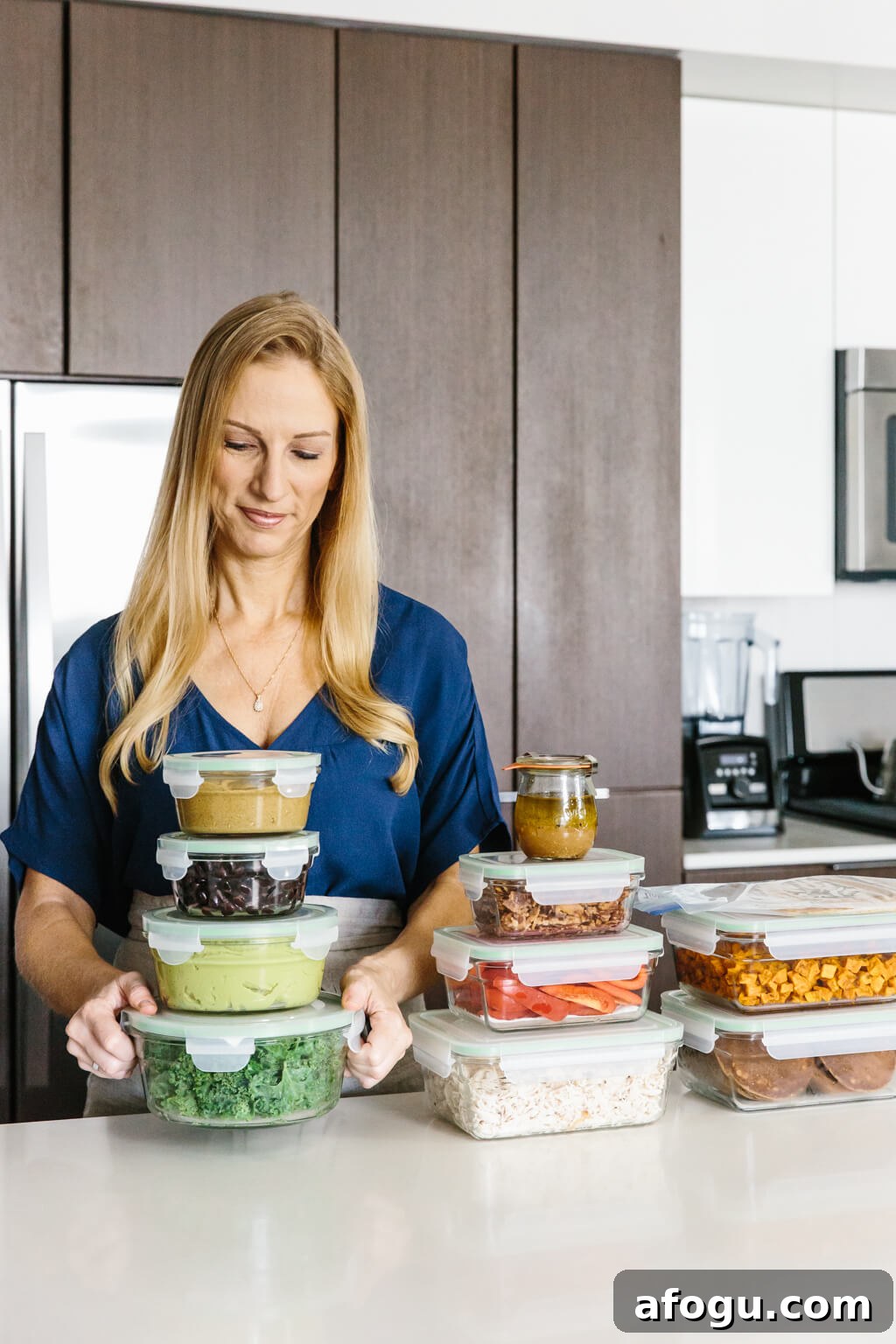 Meal prep ideas and recipes for fall! Delicious seasonal produce turned into healthy fall recipes! Girl standing with a stack of ingredients in meal prep containers.