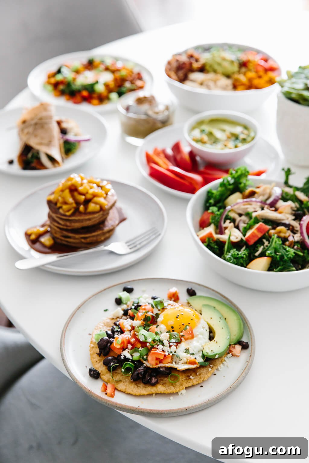 Meal prep ideas and recipes for fall! Delicious seasonal produce turned into healthy fall recipes! Several meals prepped on a white table, ready to be eaten.