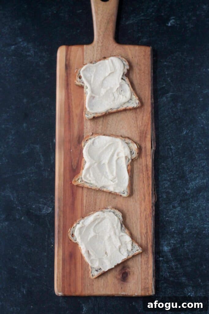 10 Creative Hummus Toast Recipes for Quick Snacks 6 Three pieces of toast spread with hummus.