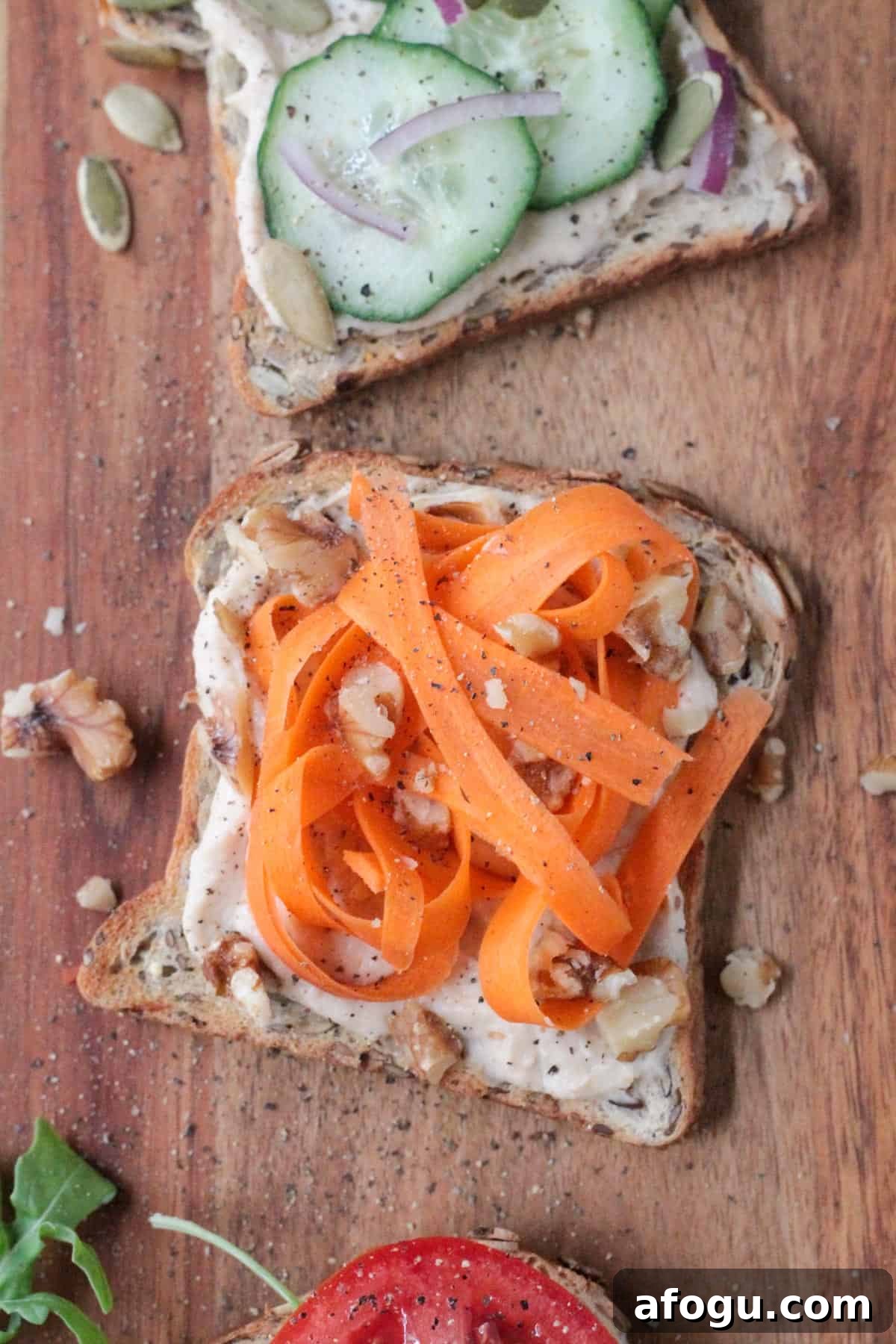 10 Creative Hummus Toast Recipes for Quick Snacks 9 Hummus toast topped with carrot ribbons and chopped walnuts.