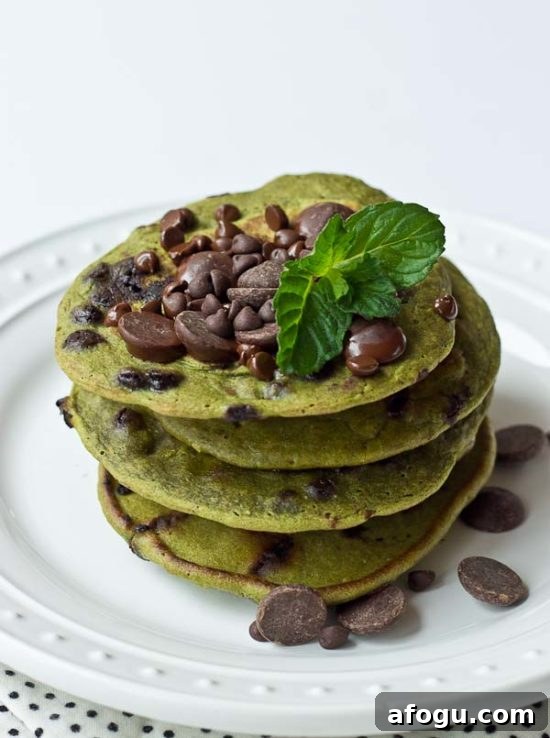 Green pancakes on a plate with chocolate chips