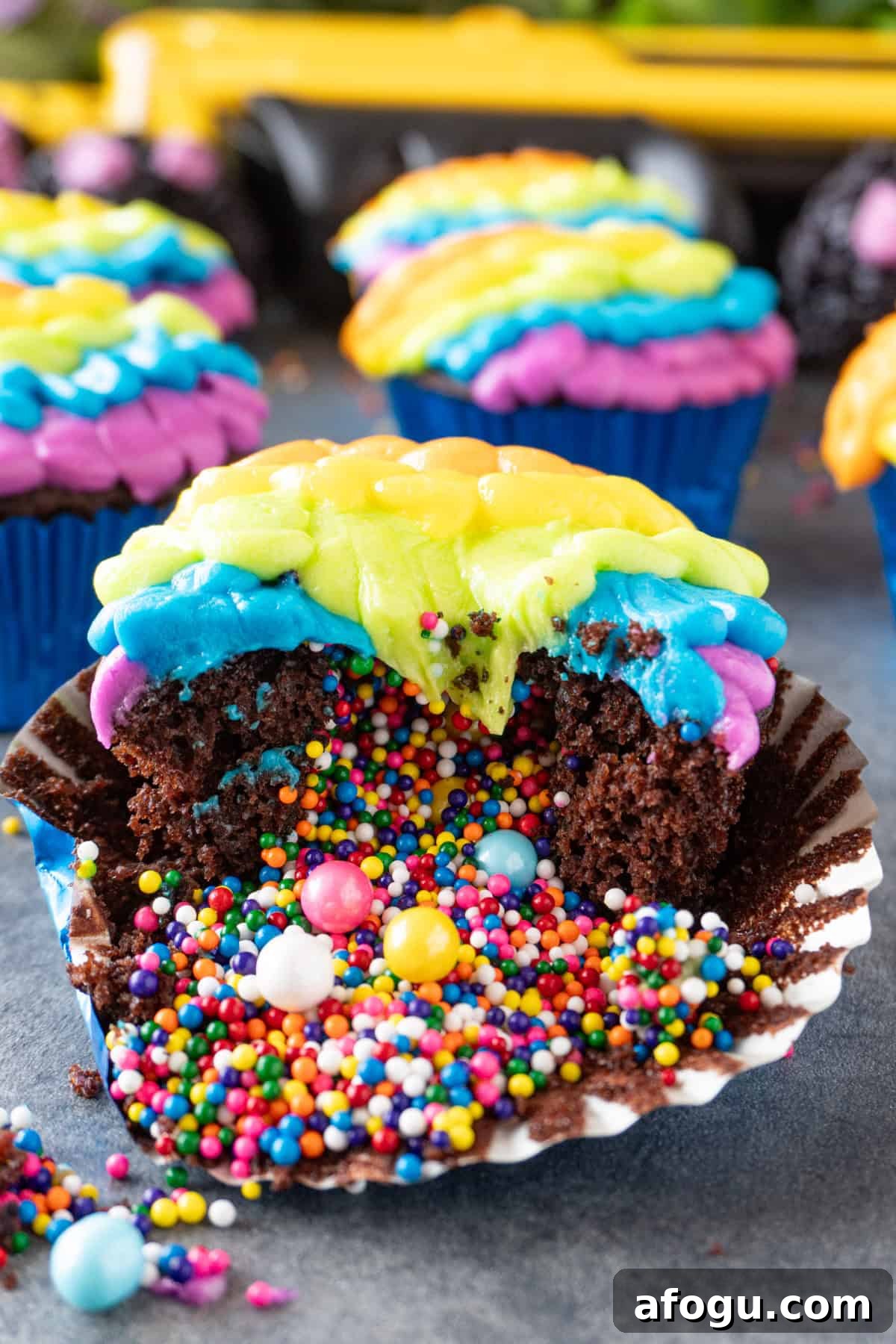 colorful pinata cupcake with colorful sprinkles spilling out