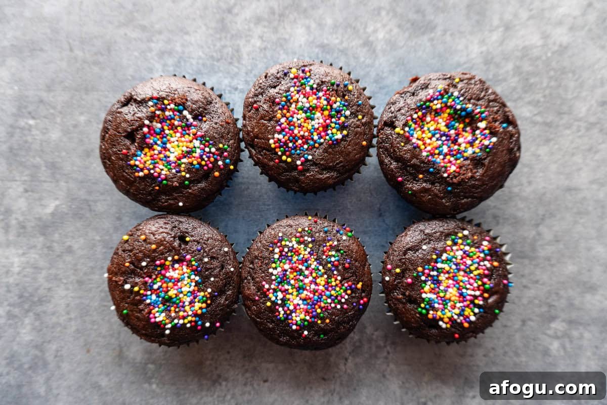 cupcakes with holes filled with sprinkles