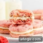 featured image of strawberry cake mix sandwich cookies with bite taken out