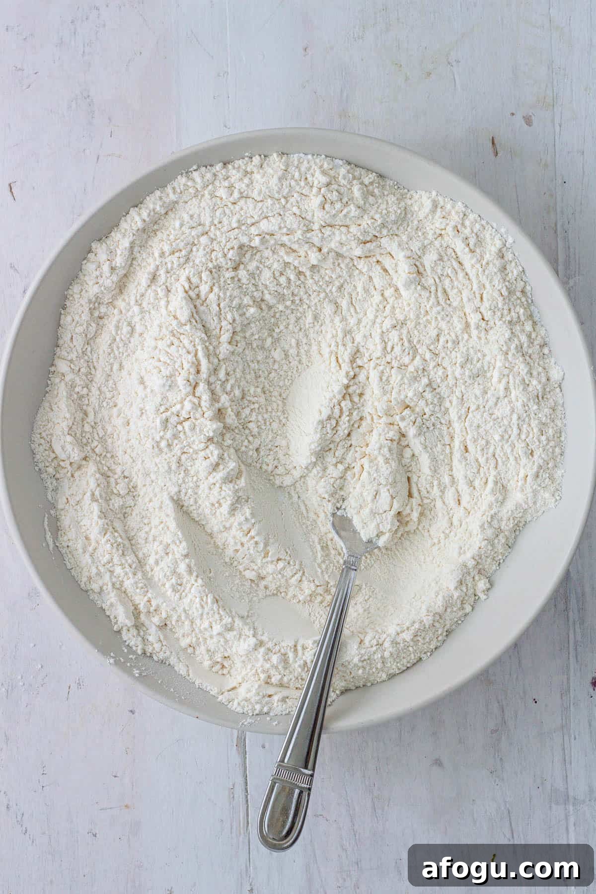 Flour, baking powder, baking soda, salt and sugar in a mixing bowl.