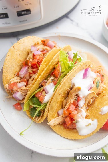 Crock Pot Ranch Chicken Tacos are so flavorful, tender, and tasty! This slow-cooker chicken is perfect for tacos, tostadas, enchiladas, salads, and burritos!