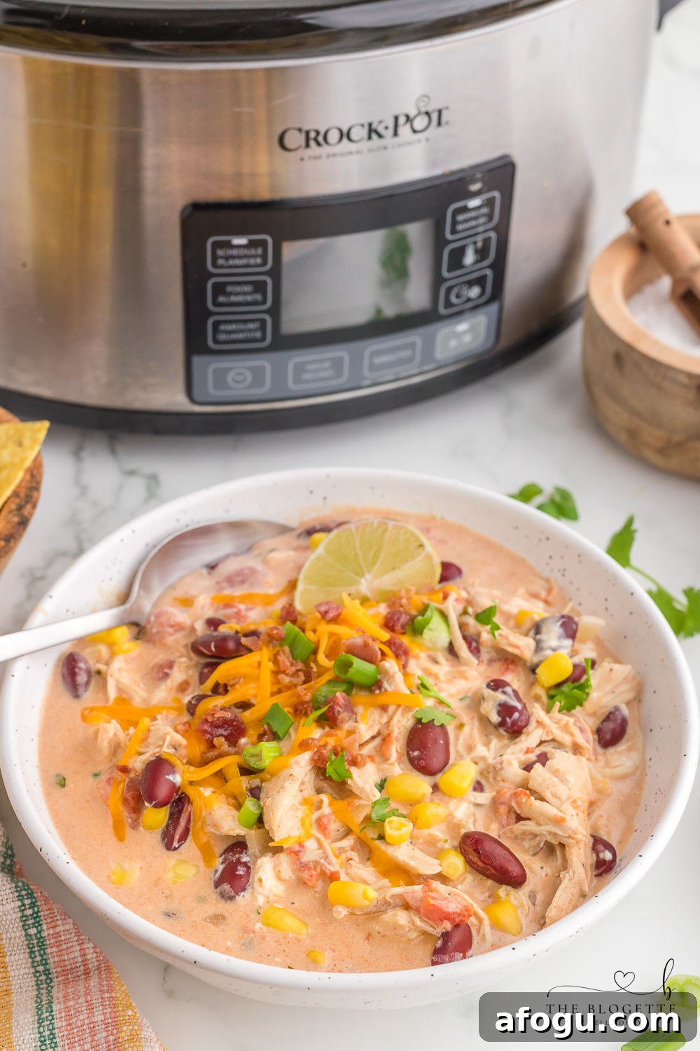 Slow Cooker White Chicken Chili is a mouthwatering dish that is a perfect blend of creamy flavors. The BEST crock pot chicken chili recipe!