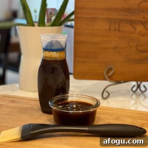 Homemade BBQ Sauce on a counter with a brush