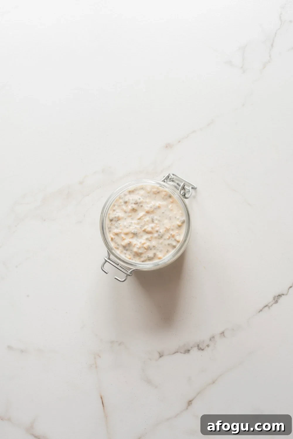 Strawberry Cheesecake Overnight Oats Recipe for Creamy Make-Ahead Breakfast 6 Jar filled with strawberry cheesecake overnight oats mixture before chilling.