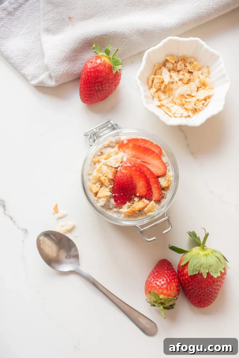 Strawberry Cheesecake Overnight Oats Recipe for Creamy Make-Ahead Breakfast 7 Strawberry cheesecake overnight oats topped with sliced strawberries and graham cracker crumbs.