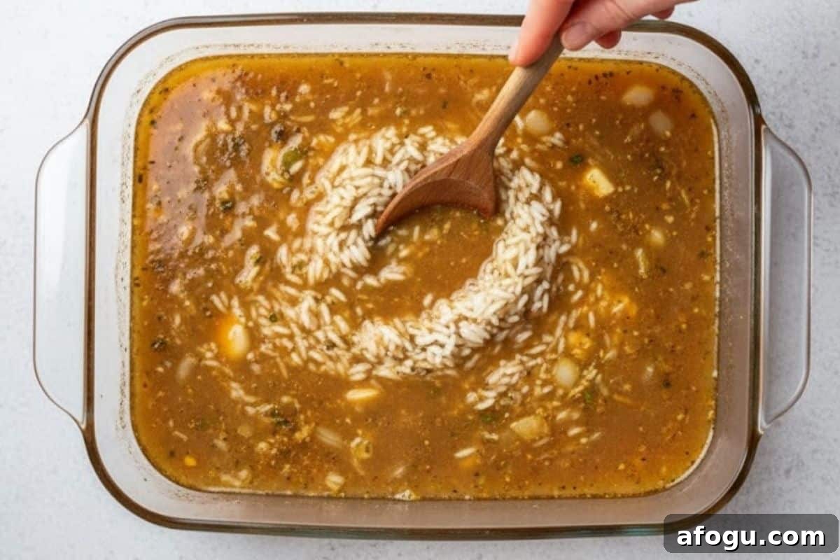 Crispy Oven-Baked Chicken with Garlic Rice Recipe 5 Grease a baking dish, add onion, garlic, oil, butter and hot broth, then add rice.