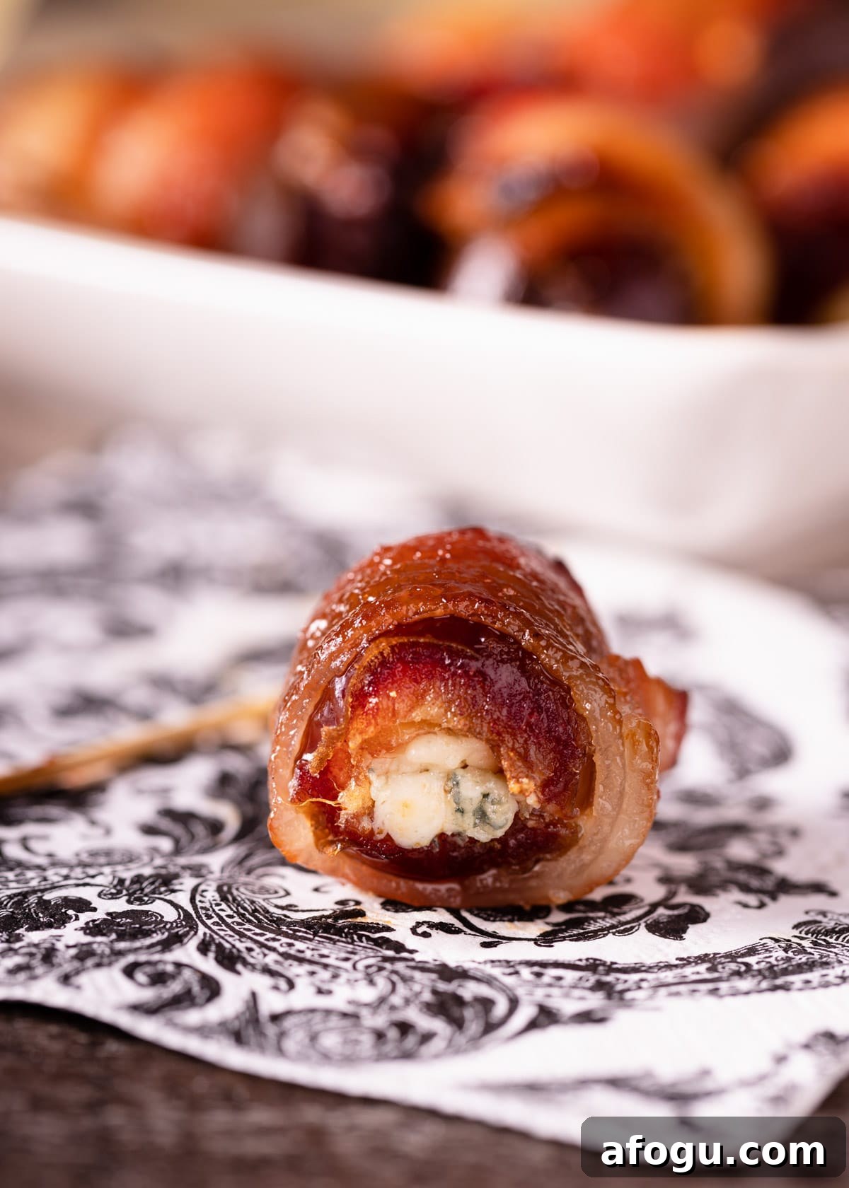 closeup of a blue cheese stuffed date on a printed napkin