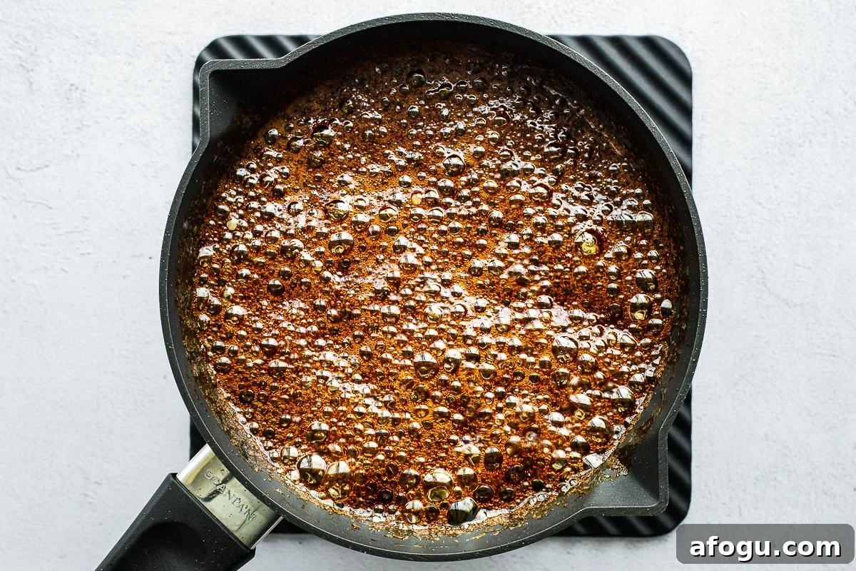 Sweet Soy Sauce Substitute: How to Replace Kecap Manis in Recipes 4 Homemade sweet soy sauce (kecap manis) boiling and bubbling vigorously in a small saucepan.