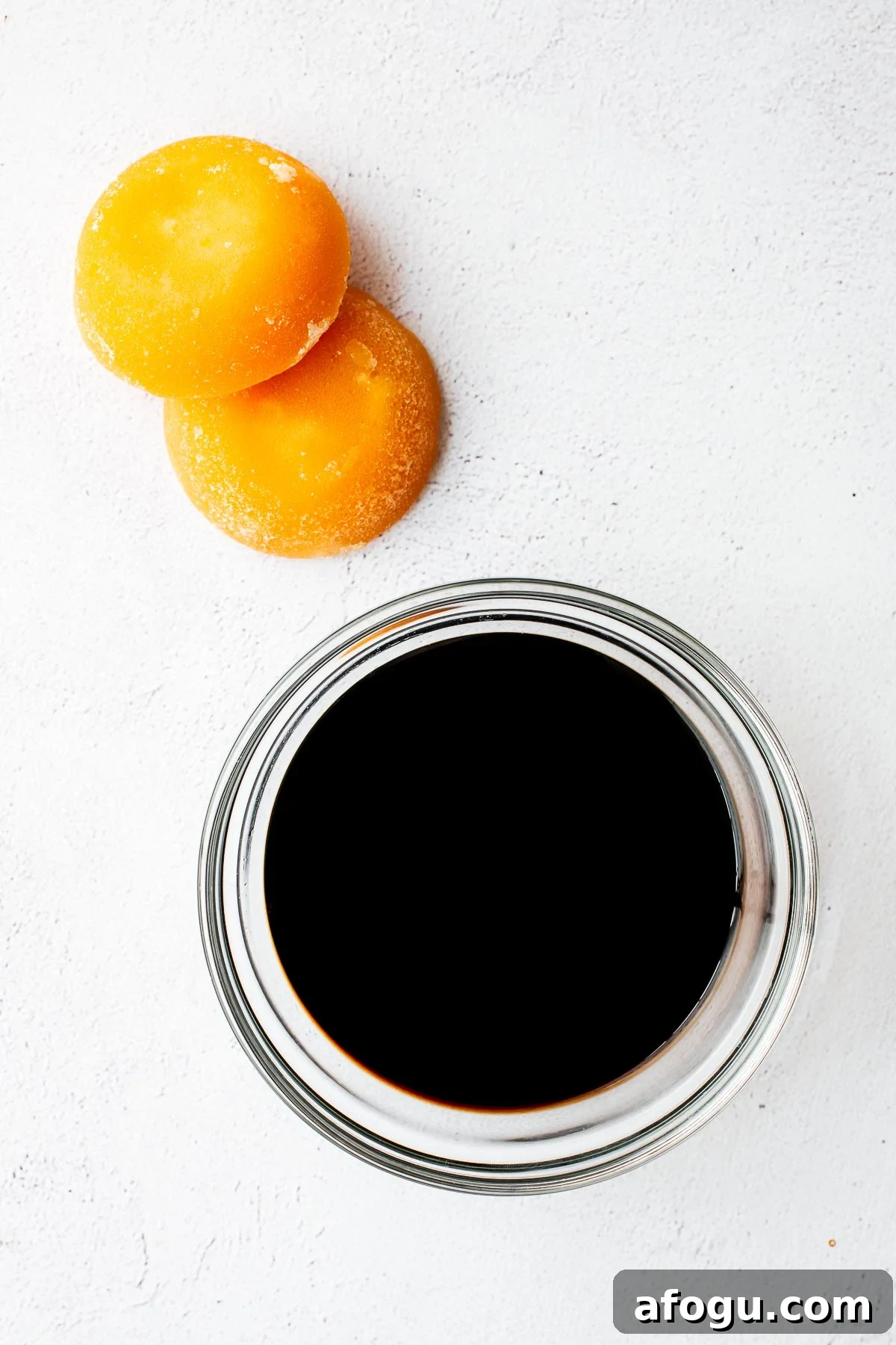 Sweet Soy Sauce Substitute: How to Replace Kecap Manis in Recipes 5 A bowl of all-purpose soy sauce and palm sugar bricks for homemade kecap manis.