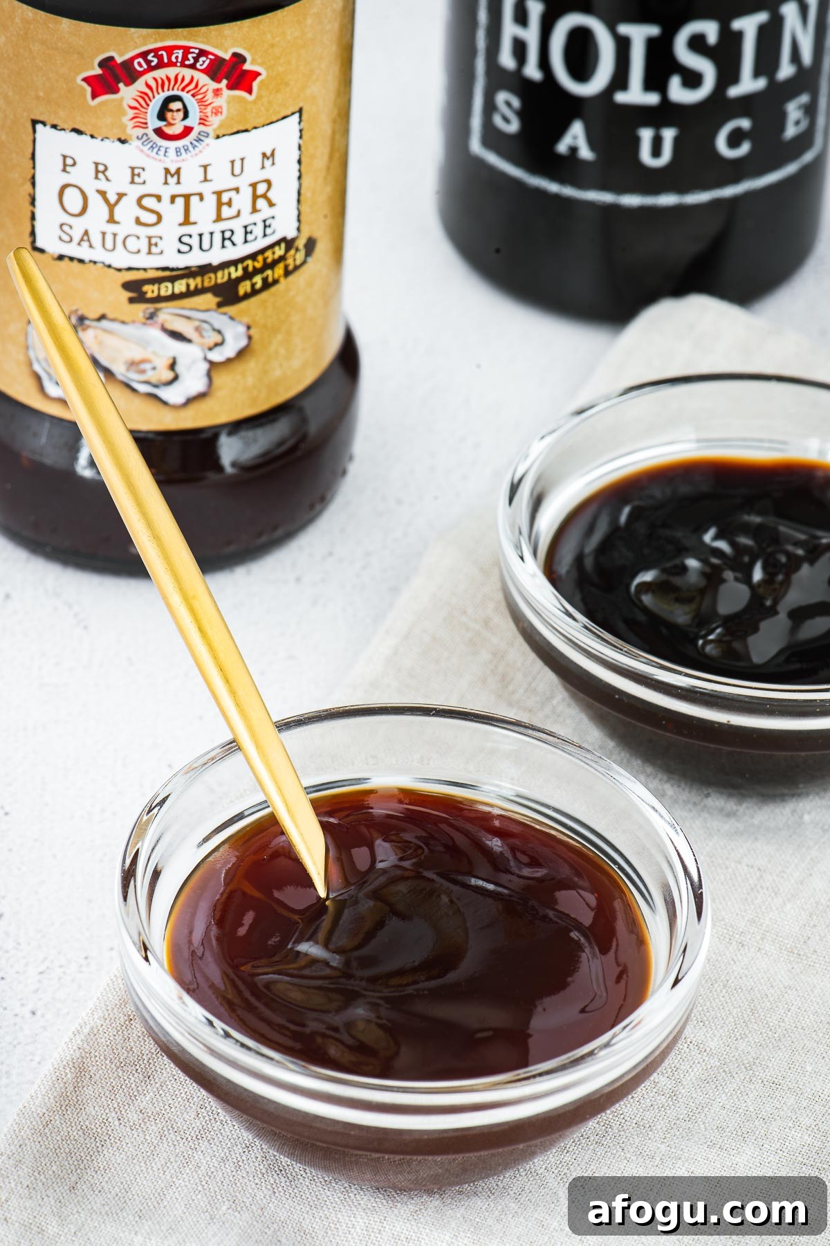 Sweet Soy Sauce Substitute: How to Replace Kecap Manis in Recipes 6 Hoisin sauce vs oyster sauce in small glass bowls with bottles in the background.
