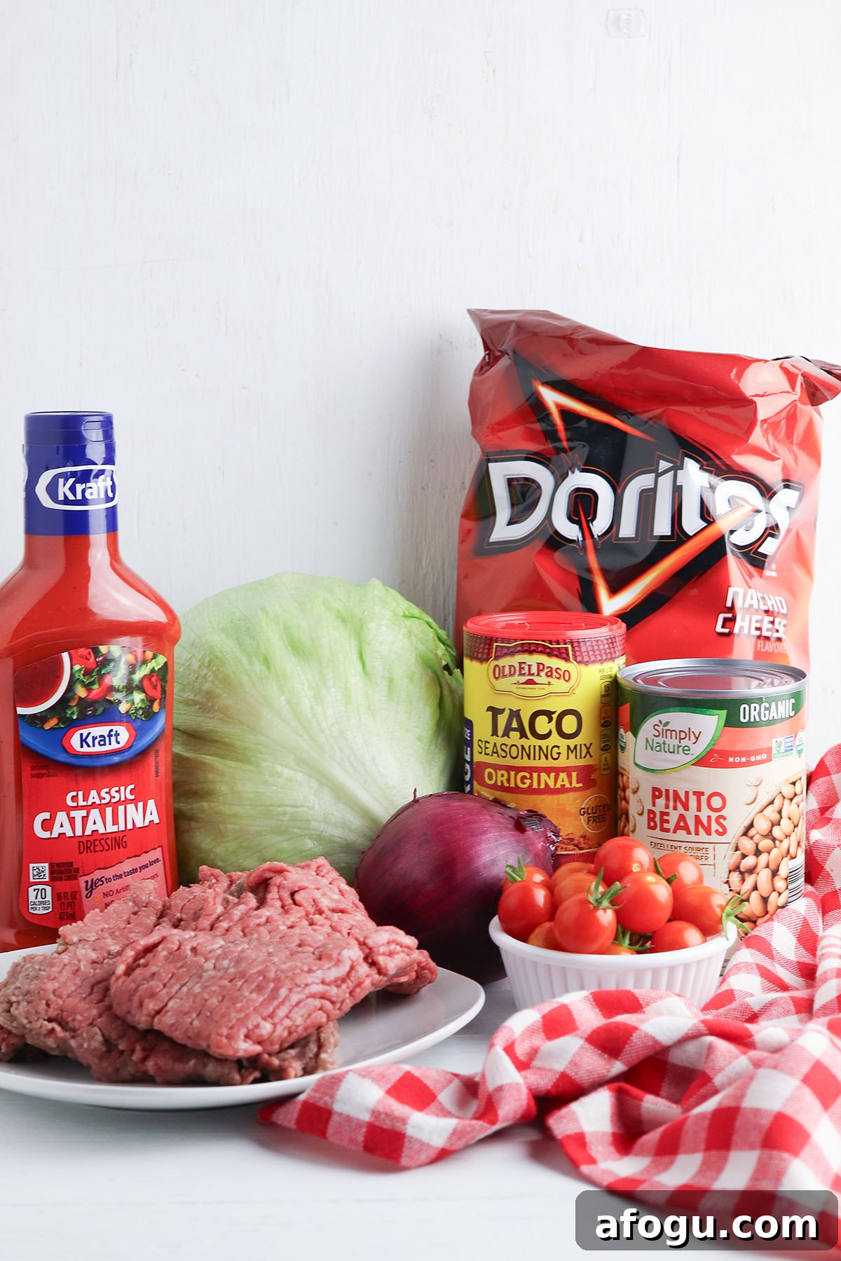 The ingredients to make Dorito taco salad are set out on the counter.