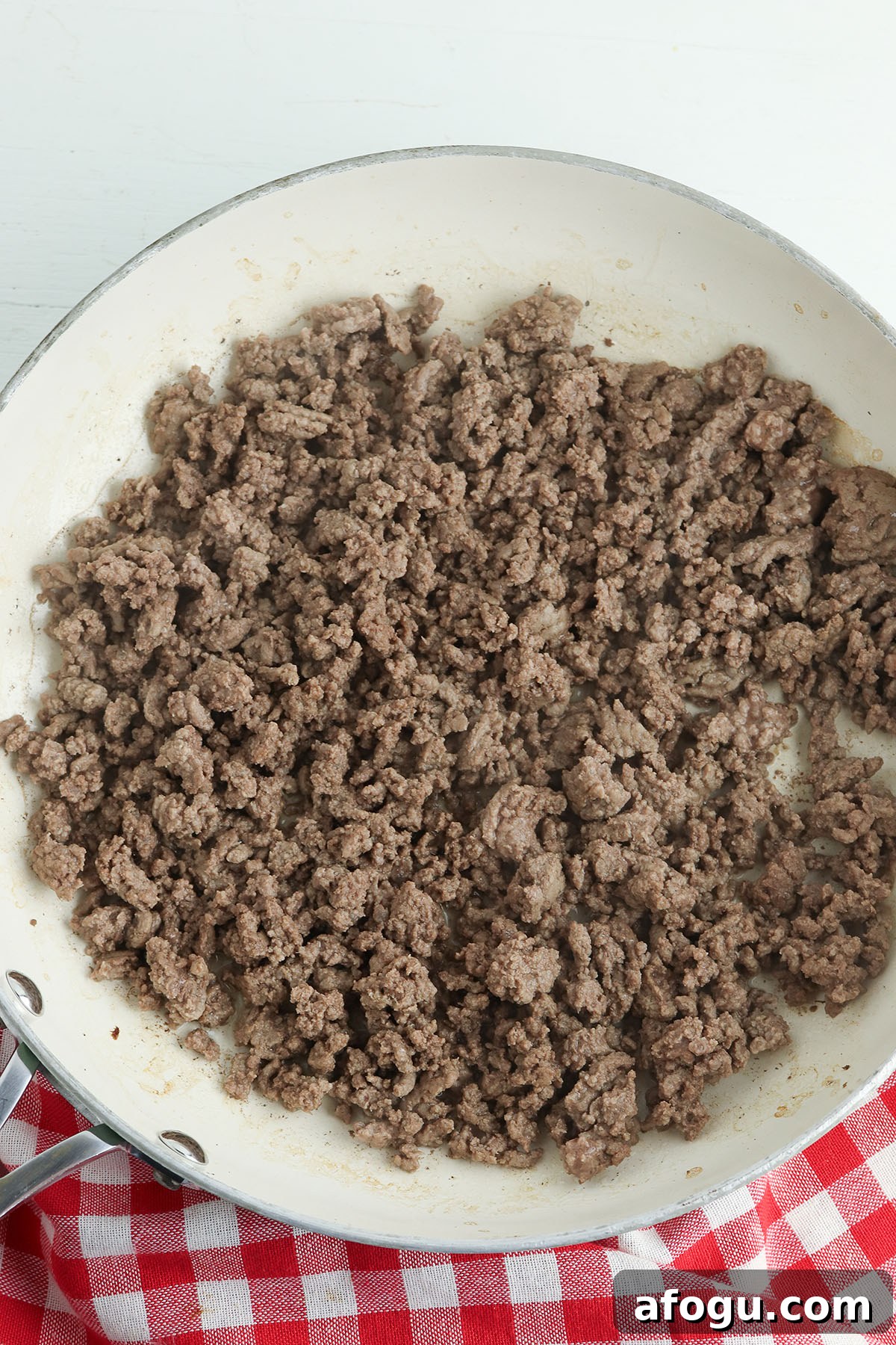 Browned ground beef in a skillet.