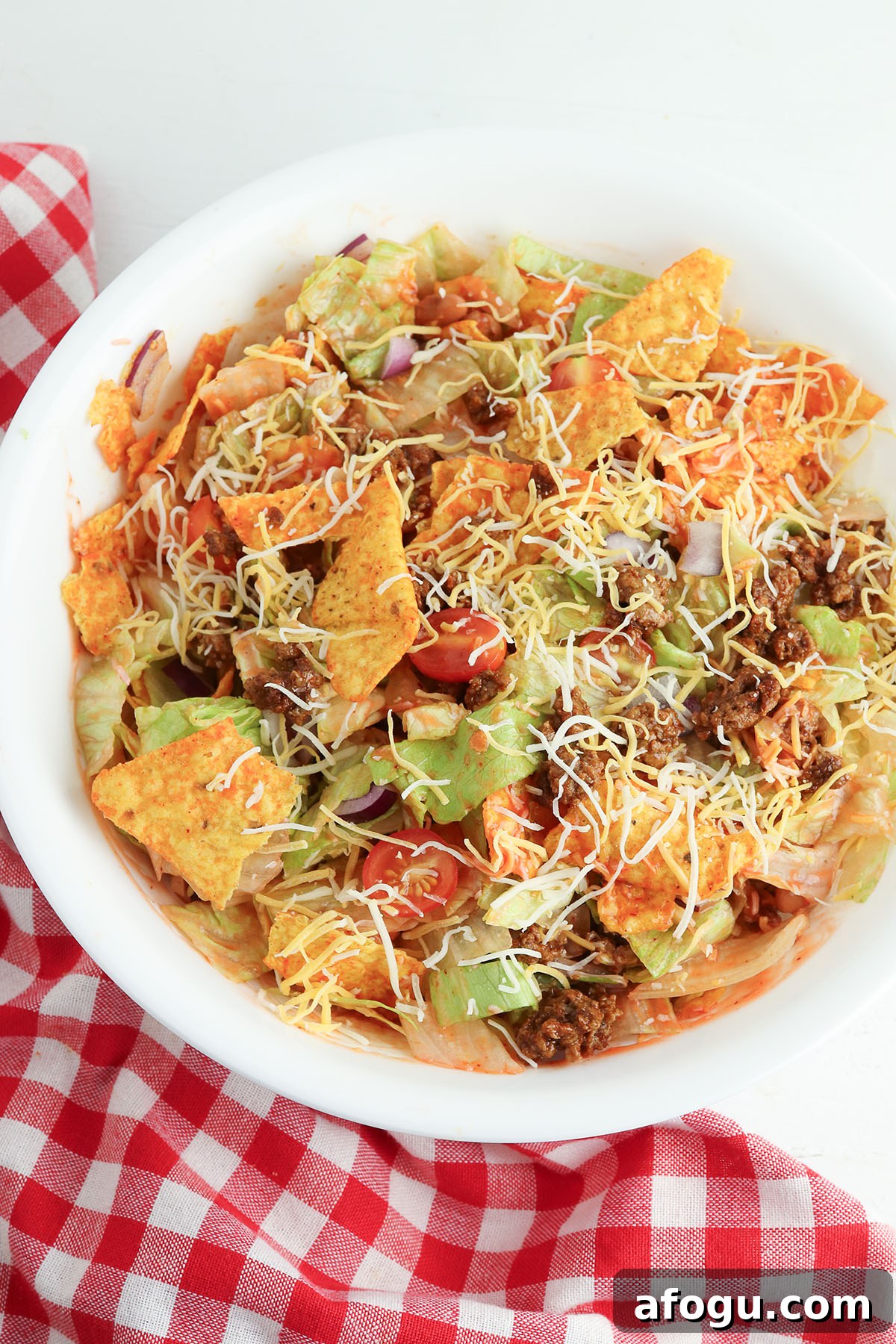 Dorito Taco Salad tossed in large bowl.