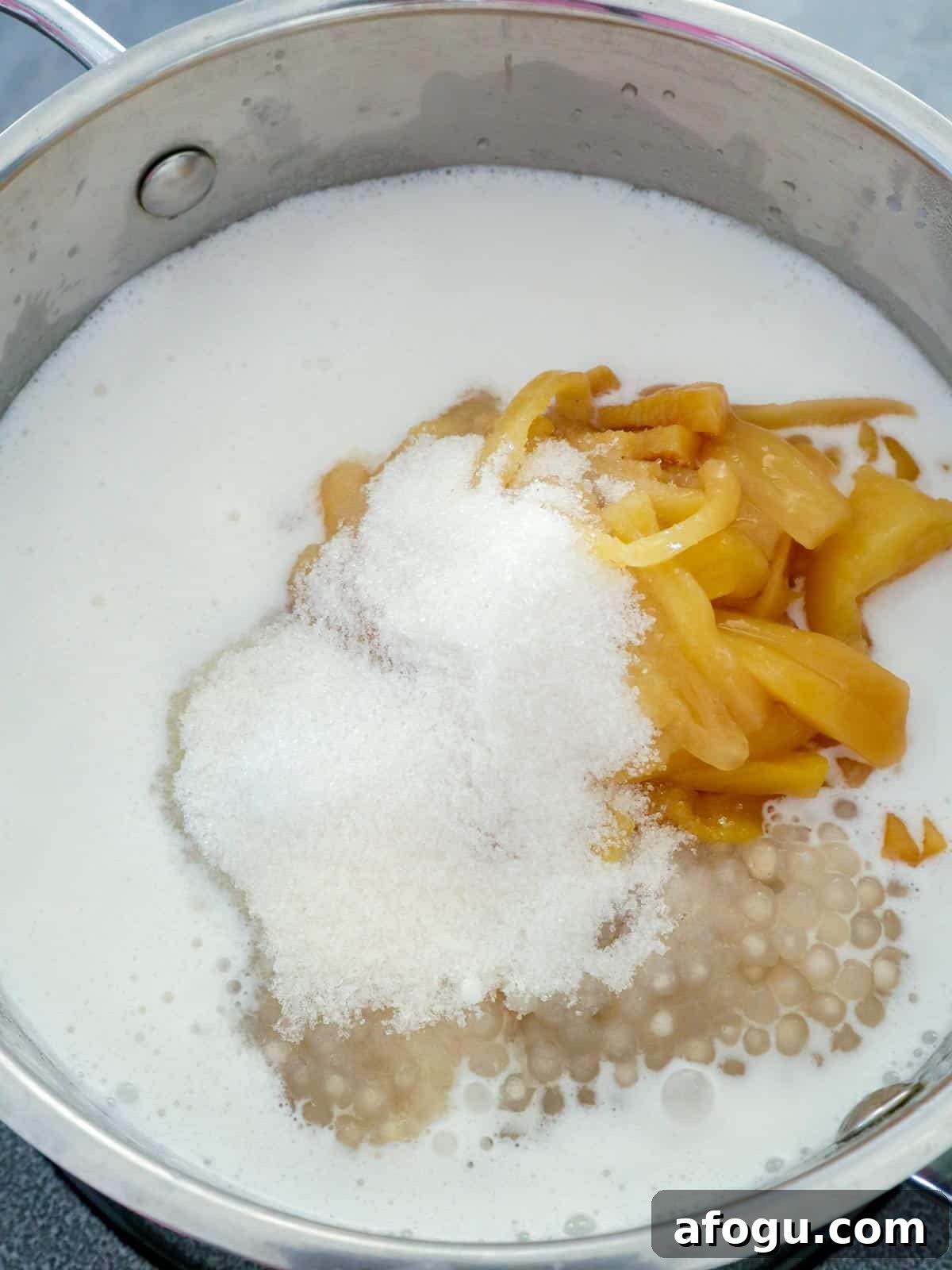 cooking ginataang kamoteng kahoy in a pot