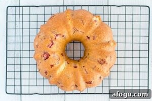 fresh strawberry Bundt cake cooling on a rack