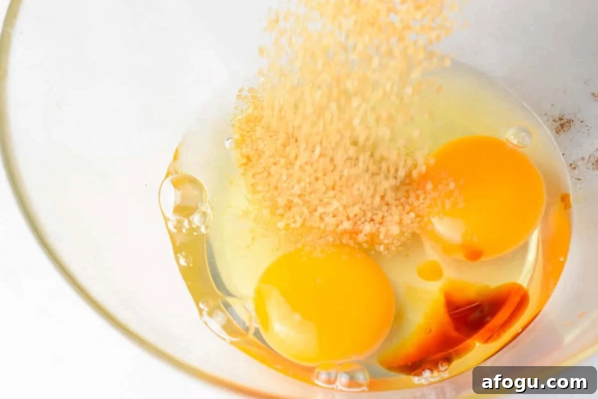 eggs, sugar, and vanilla extract in a glass bowl.