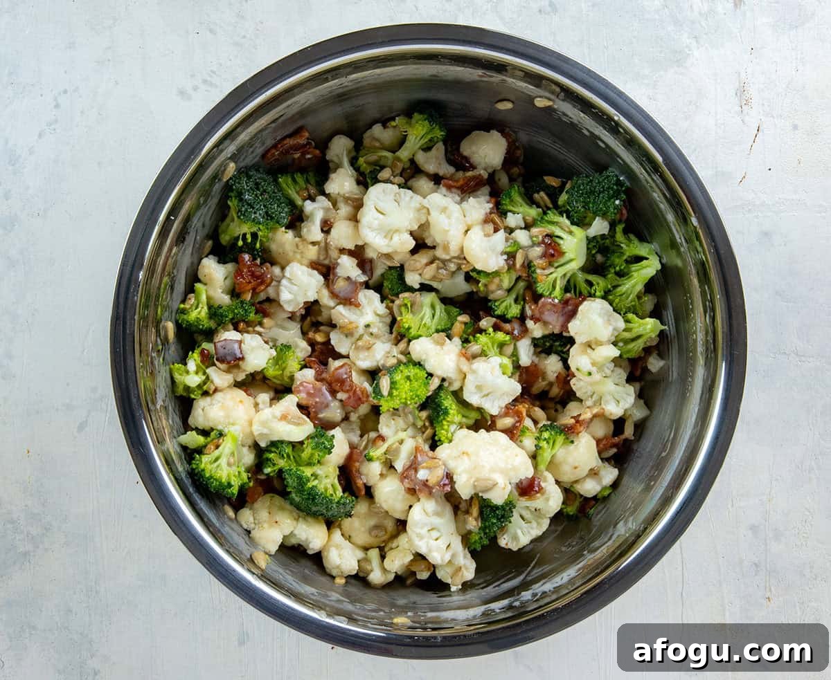 Chopped broccoli and cauliflower, chopped bacon, and sunslower seeds added to the creamy mayonnaise mixture.