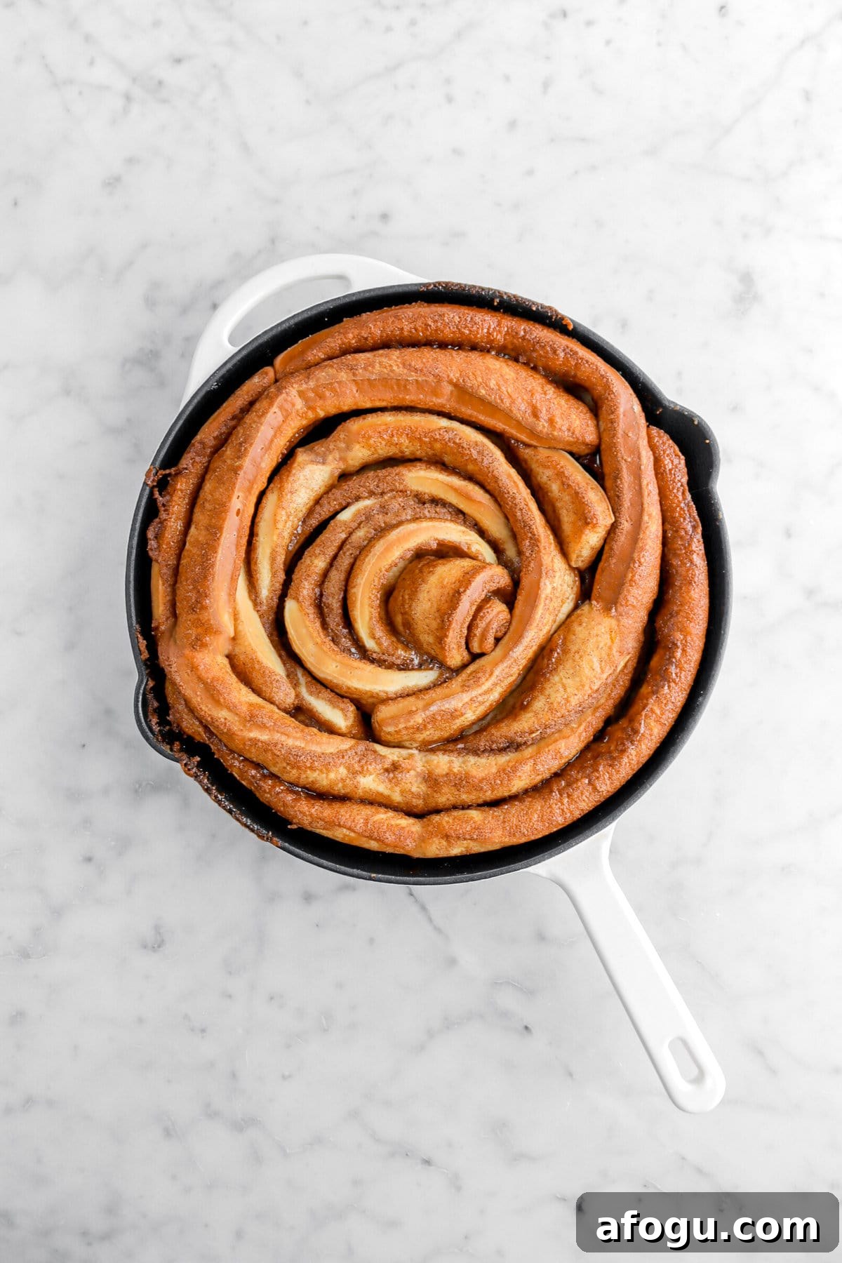 baked giant cinnamon roll in skillet.