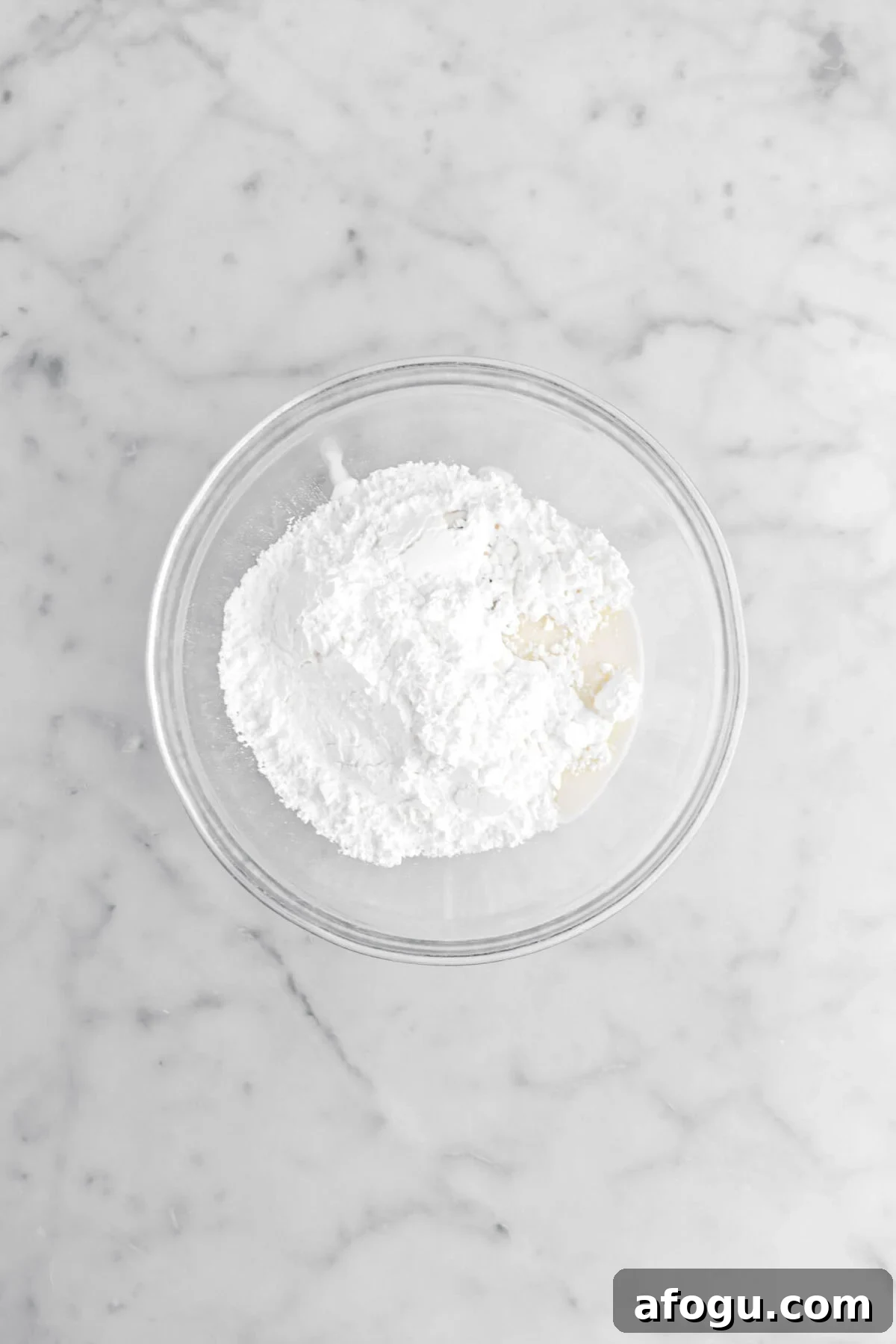 powdered sugar, milk, and vanilla in glass bowl.