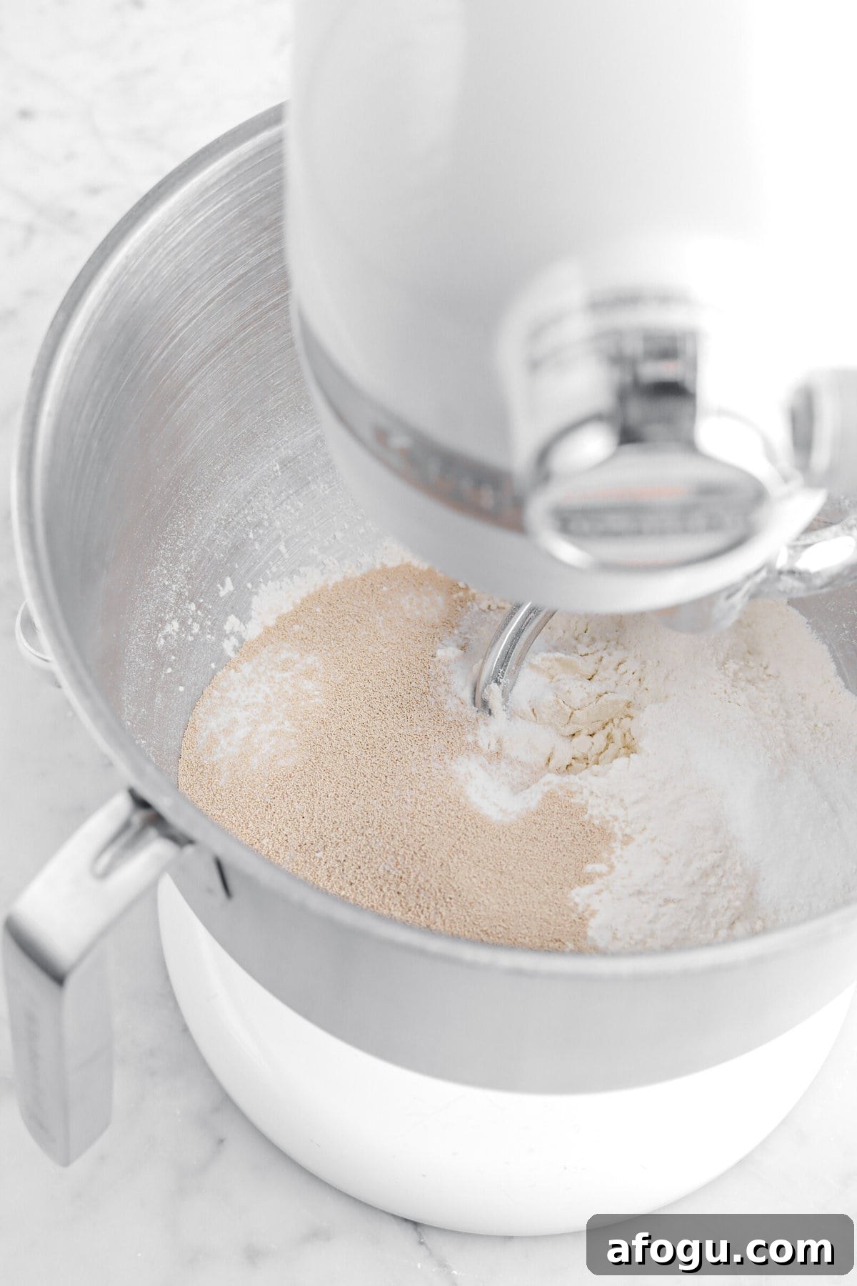 yeast, salt, flour, and sugar in stand mixer.
