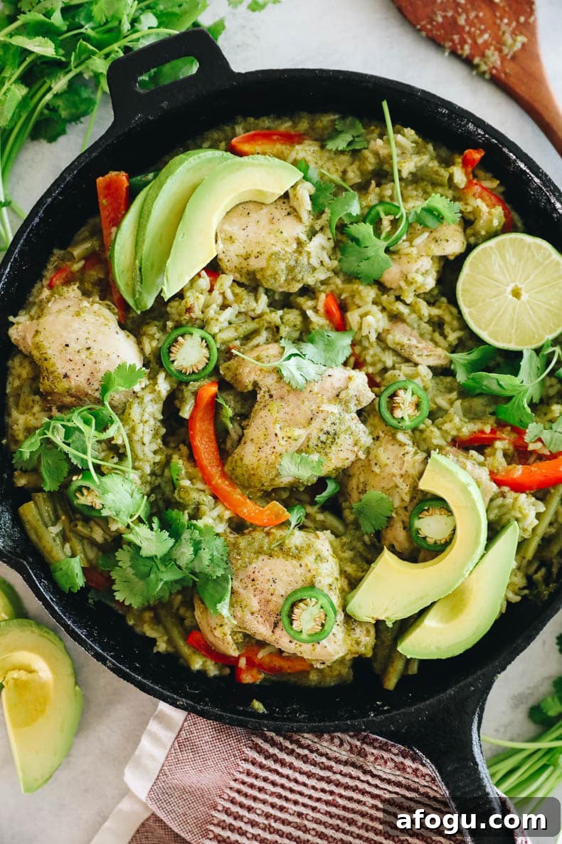 Cilantro Lime Chicken and Rice Recipe — One-Pot Dinner 2 cilantro lime chicken thighs with rice and veggies in a cast iron pan