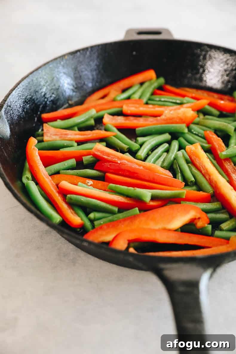 Cilantro Lime Chicken and Rice Recipe — One-Pot Dinner 4 cooked bell pepper and green beans in a cast iron