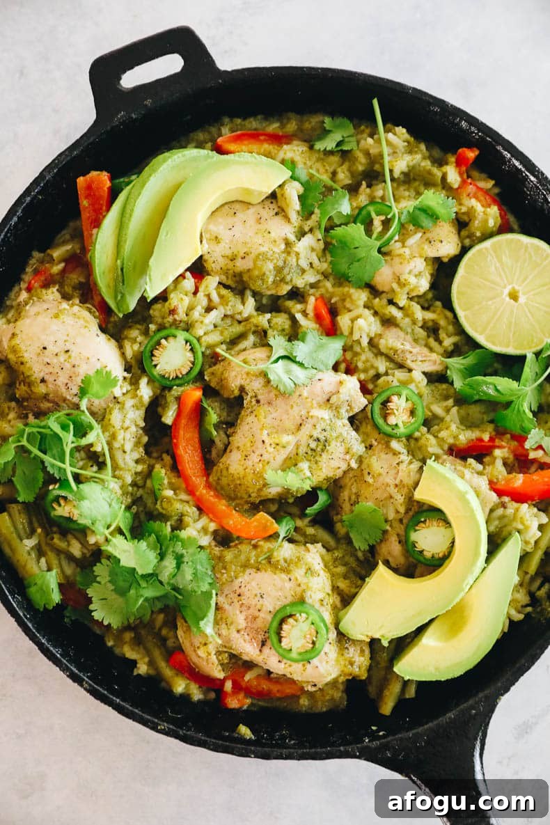 Cilantro Lime Chicken and Rice Recipe — One-Pot Dinner 6 cooked cilantro lime chicken in a cast iron topped with fresh avocado, cilantro and jalapeno.