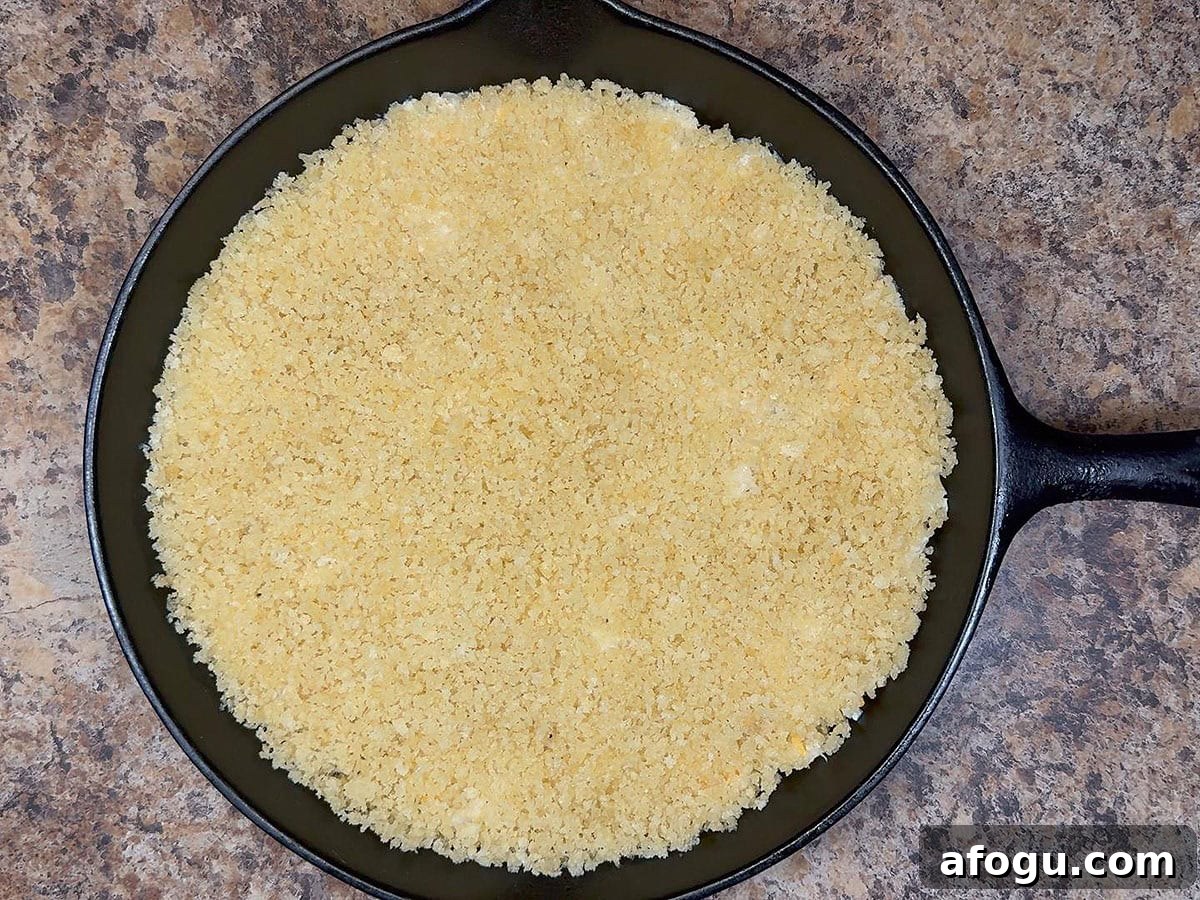 Creamy Cauliflower and Cheese Casserole Recipe 6 Mashed cauliflower spread into an even layer on the bottom of a greased cast iron skillet and topped with Panko breadcrumbs.