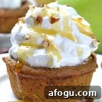 Plate with a skinny apple pie cupcake frosted with whipped cream