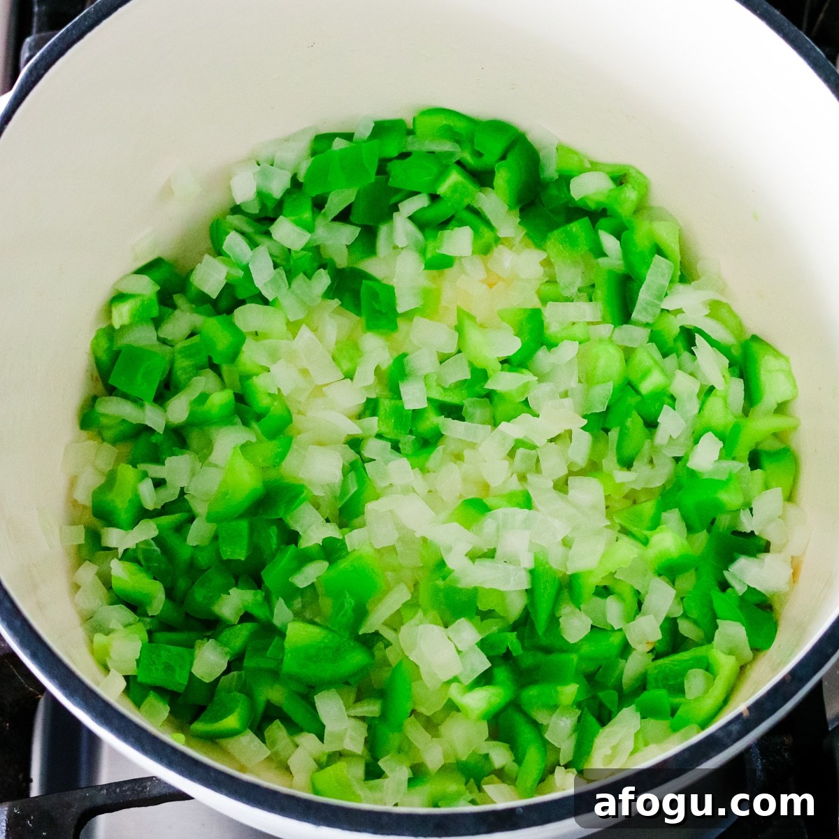 onion and bell pepper being added and cooked.