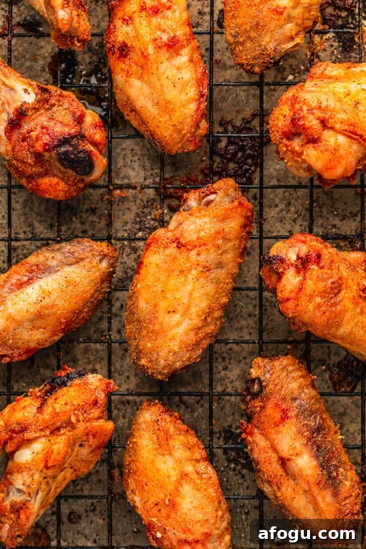 Crispy Dry-Rub Chicken Wings — Oven or Air Fryer Recipes 11 Baked chicken wings on a wire rack.