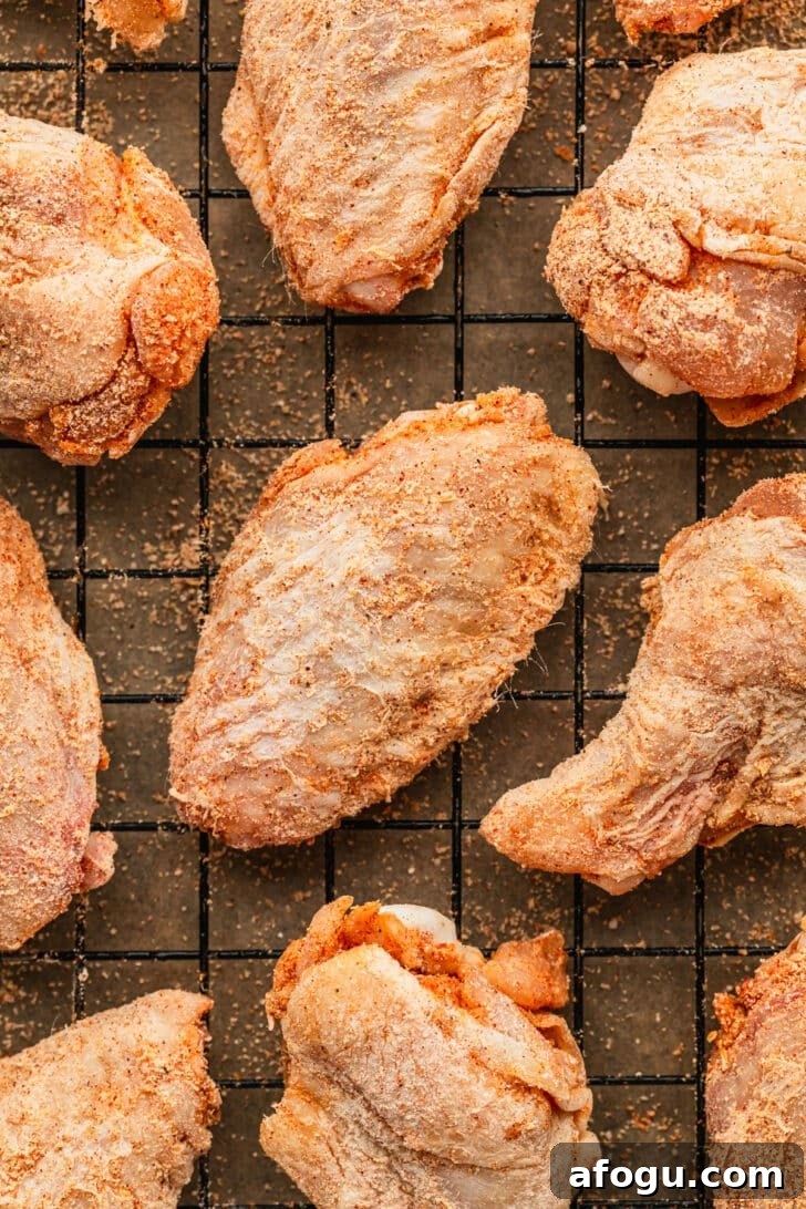 Crispy Dry-Rub Chicken Wings — Oven or Air Fryer Recipes 10 Raw dry rub wings on a wire rack.
