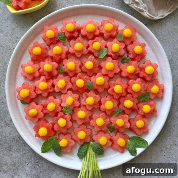 Elegant Fruit Platter Ideas for Special Occasions 5 A round plate displays a delightful fruit bouquet of flower-shaped watermelon slices topped with yellow mango balls.