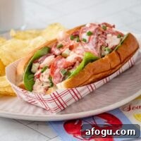 A generously filled lobster roll in a toasted New England hot dog roll.