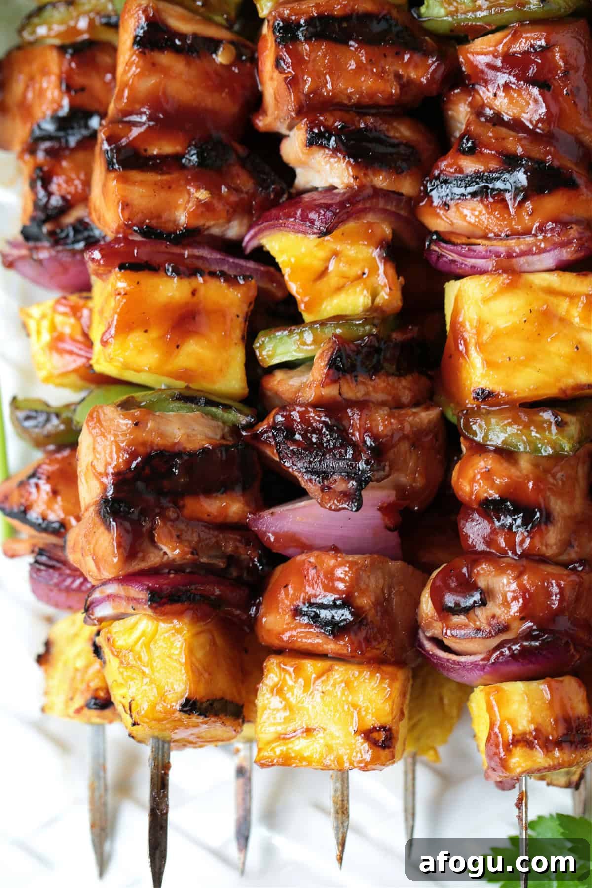 close up of chicken and pineapple kabobs on skewers