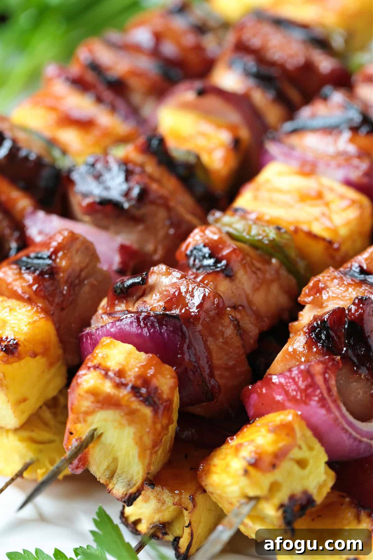 grilled chicken kabobs stacked on platter